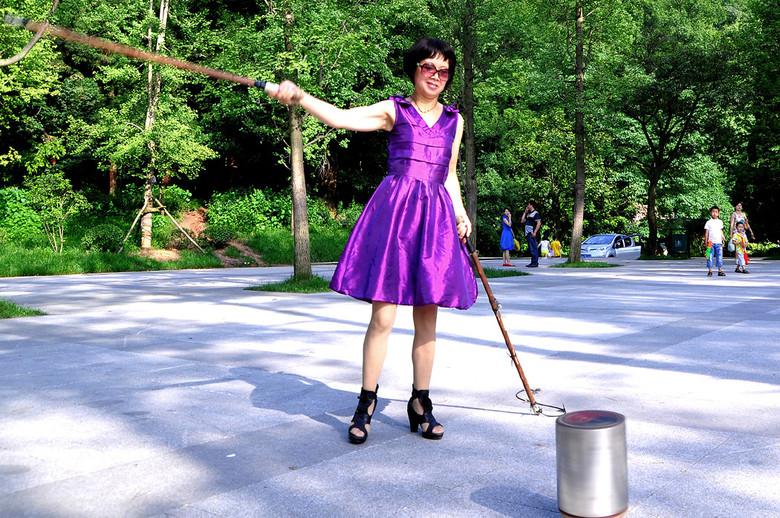 侠女双手执鞭玩大陀螺