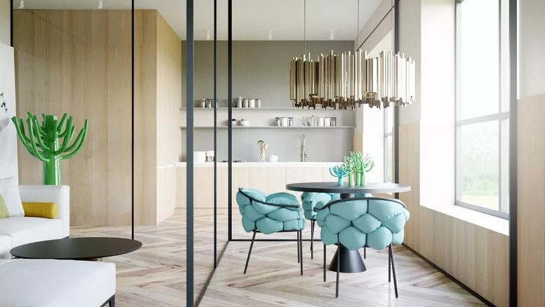 餐厅被玻璃墙隔开,一盏艺术吊灯在餐桌的正上方,搭配蓝色的椅子时尚又